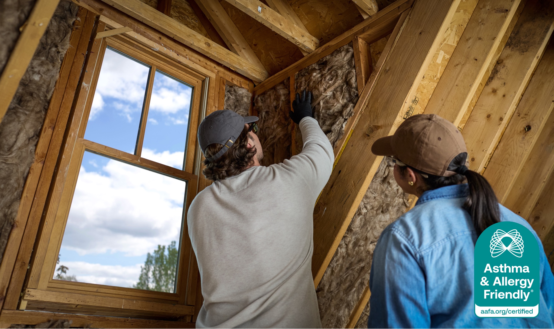 Contractors installing Knauf Performance+® insulation, Certified Asthma & Allergy Friendly®, supporting better indoor air quality.