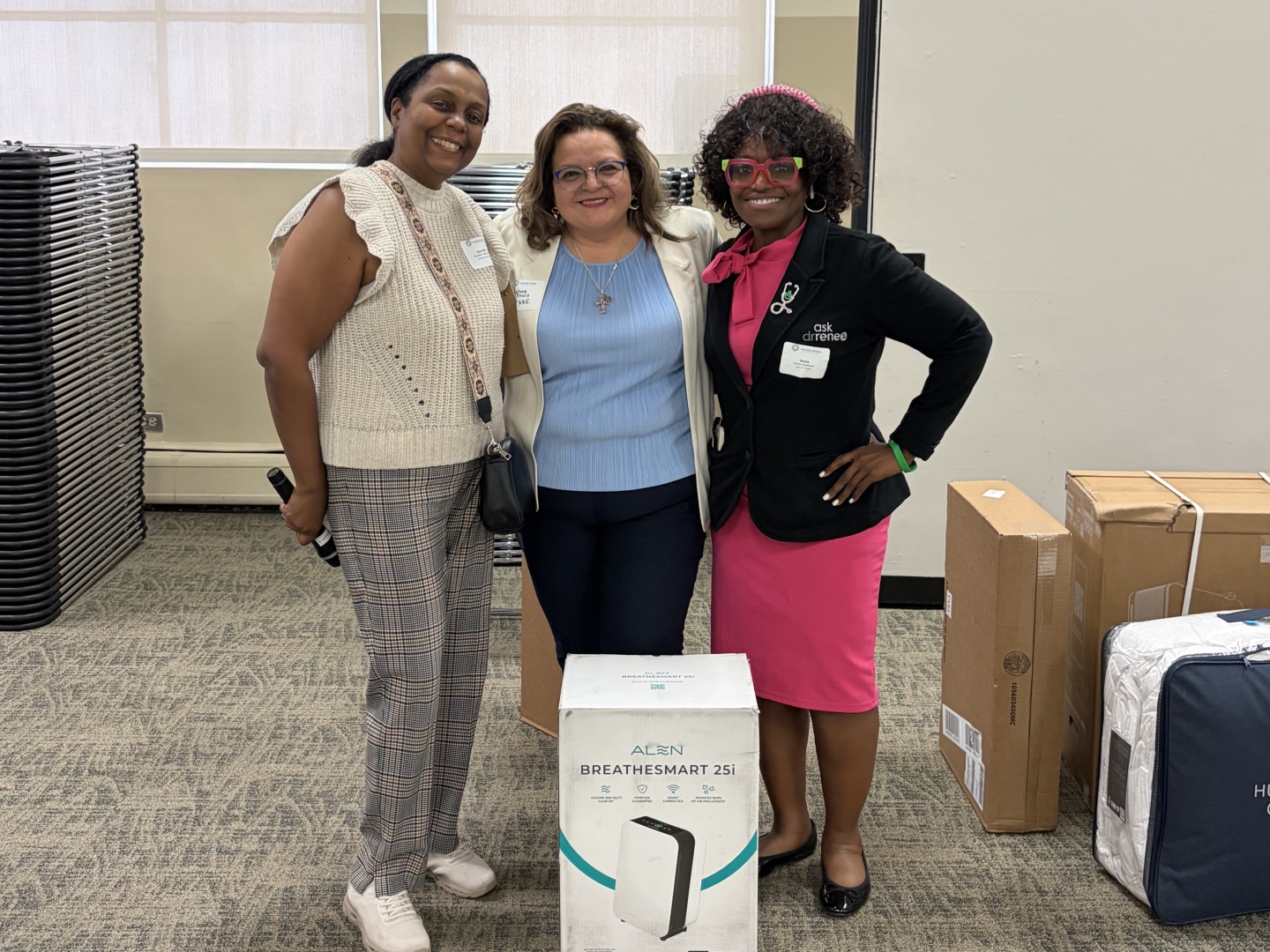Rachelle Paul-Brutus, Executive Director of the Chicago Asthma Consortium, with Certified partner product donations including the Alen air purifier at the 2026 Community Health Worker Educational Forum.