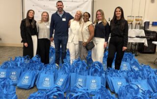 Representatives from Knauf North America, the Chicago Asthma Consortium, and the Asthma & Allergy Friendly Certification Program with 300 packed Resource Tote Bags at the 2026 Community Health Worker Educational Forum, Sinai Chicago.